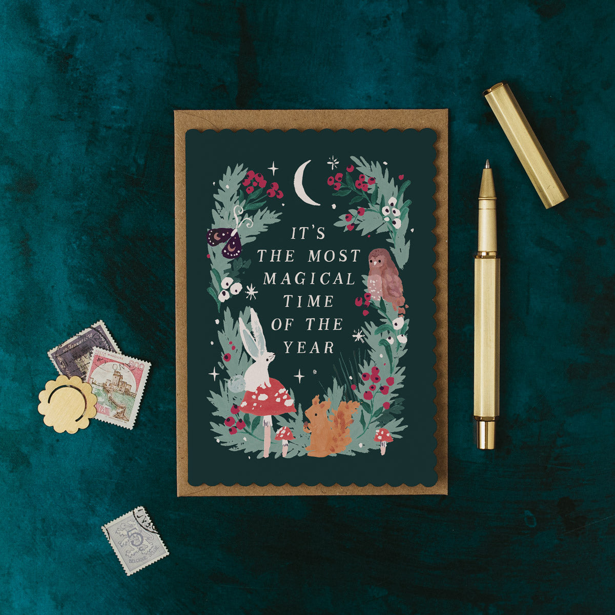 Woodland Christmas card with nature-themed illustration and text on a dark green background