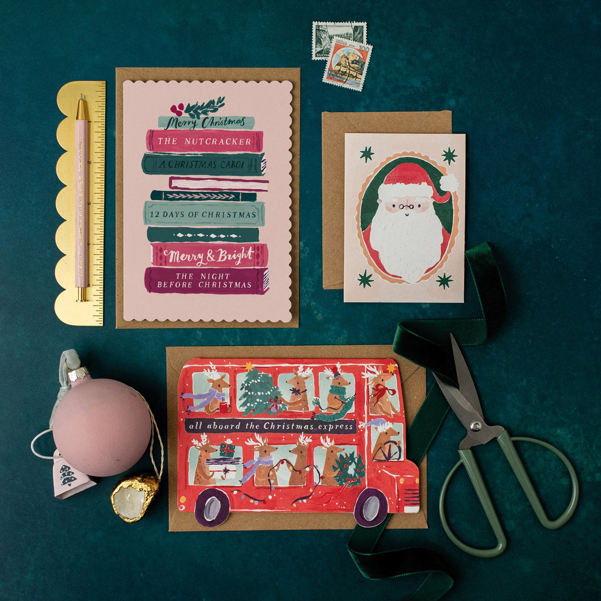 Collection of Holiday & Christmas cards and stationery items on a dark green background