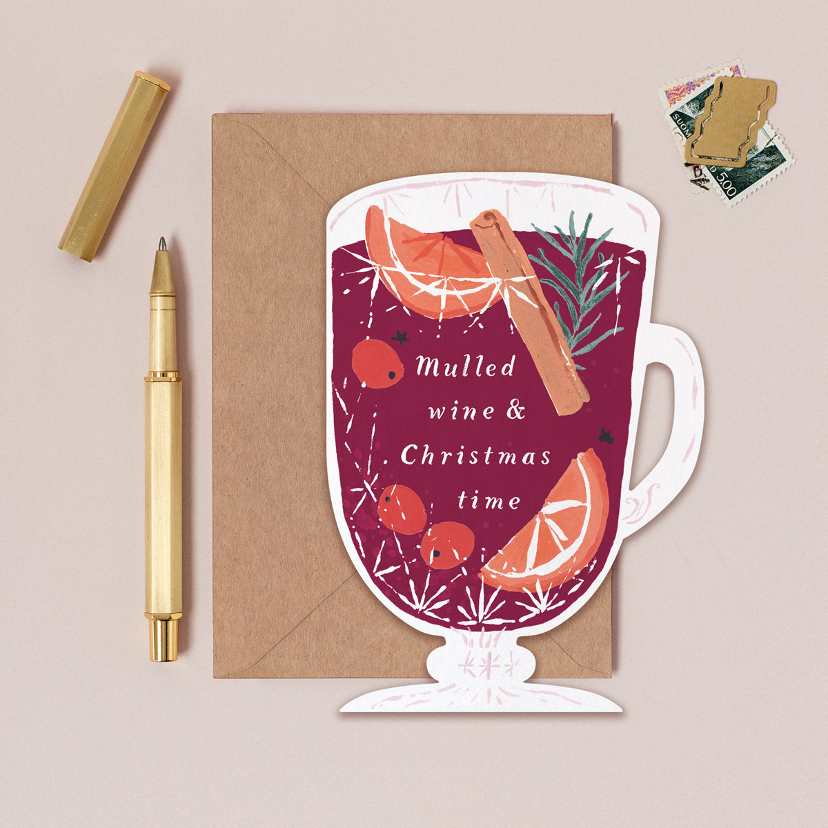Christmas card with mulled wine design and envelope on a beige background