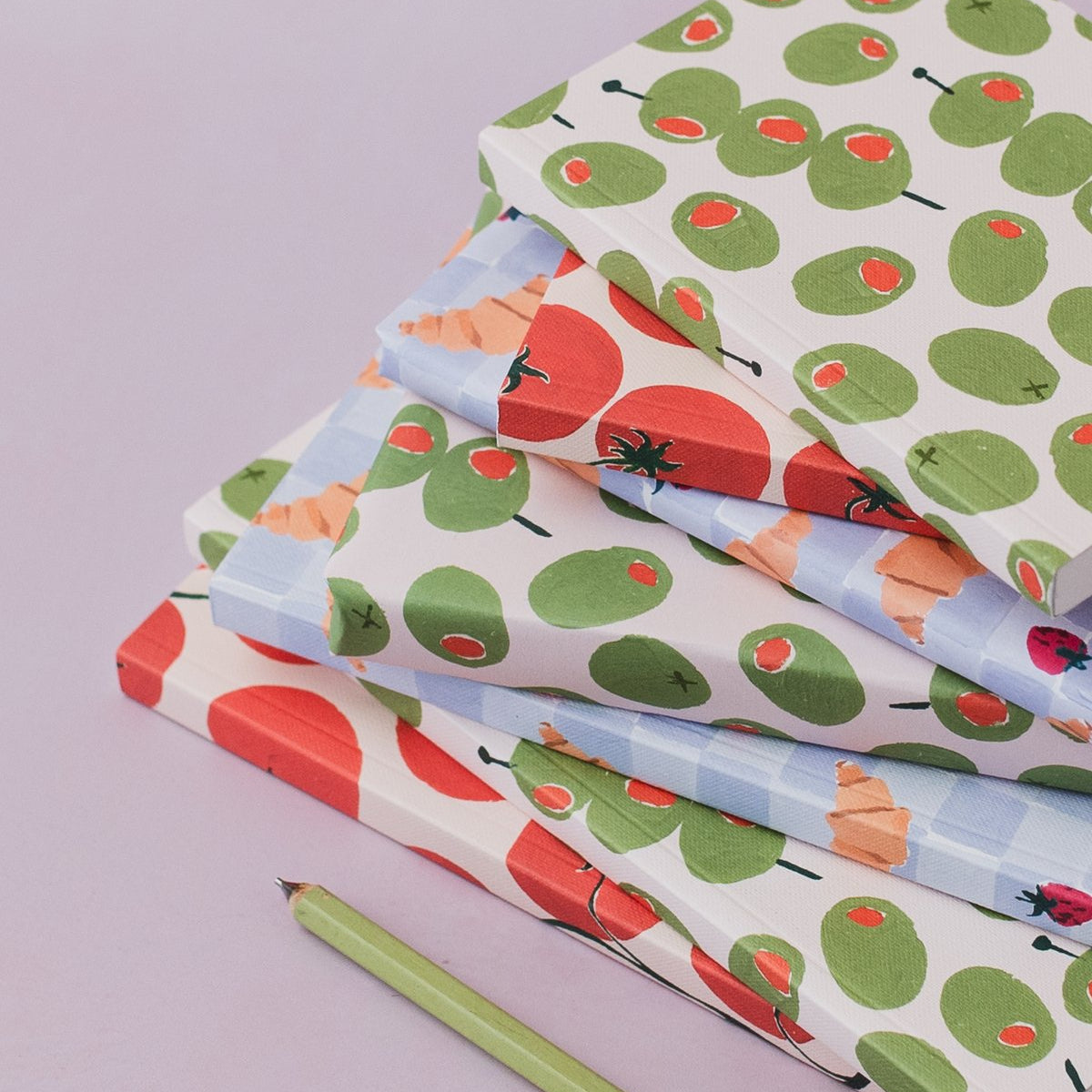Sister Paper Co olives notebook and gift wrap styled together