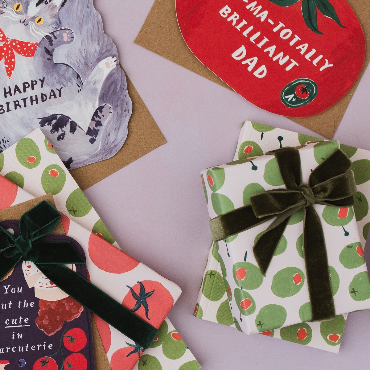 Sister Paper Co cards, notebooks and olives gift wrap styled in a flat lay
