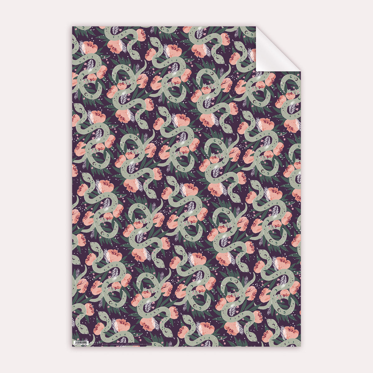 A mystical, floral snake print on wrapping paper from the female birthday wrapping paper collection at Sister Paper Co.