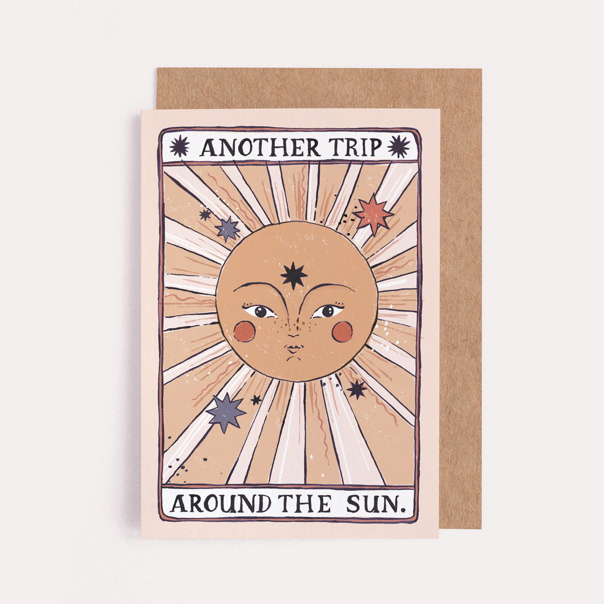 A handmade tarot style card with illustrated beautiful sun and another trip around the sun hand lettering on a birthday card from the female birthday card collection at Sister Paper Co.