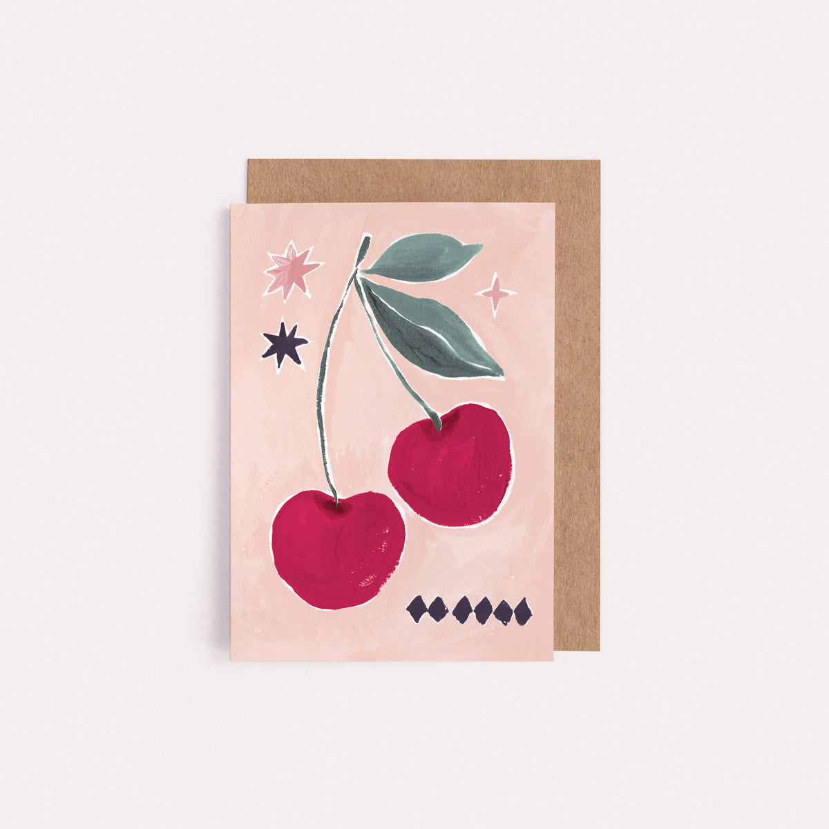 A mini greeting card with an illustrated cherries and stars from the wholesale mini greeting card collection at Sister Paper Co.