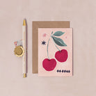 A mini greeting card with an illustrated cherries and stars from the wholesale mini greeting card collection at Sister Paper Co.