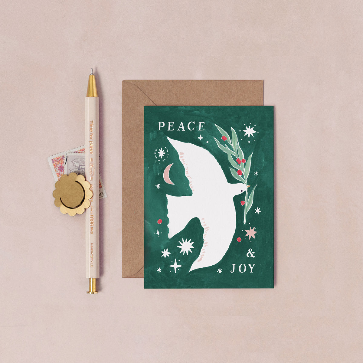 A mini Christmas card with an illustrated peace dove from the wholesale mini Christmas card collection at Sister Paper Co.