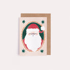 A mini Christmas card with an illustrated festive santa from the wholesale mini Christmas card collection at Sister Paper Co.