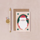 A mini Christmas card with an illustrated festive santa from the wholesale mini Christmas card collection at Sister Paper Co.