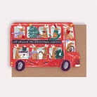 A Christmas card cut into the shape of bus full of reindeer from the wholesale Christmas card collection at Sister Paper Co.