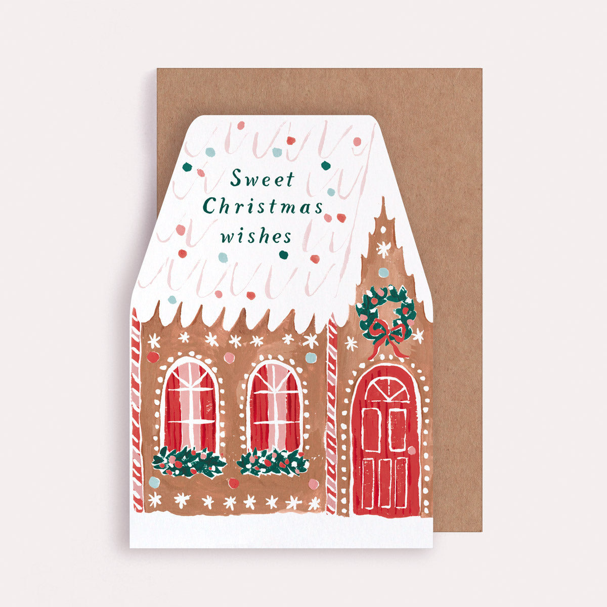 A Christmas card cut into the shape of a gingerbread house from the wholesale Christmas card collection at Sister Paper Co.