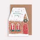 A Christmas card cut into the shape of a gingerbread house from the wholesale Christmas card collection at Sister Paper Co.