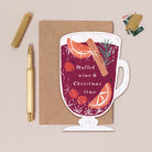 Christmas card with mulled wine design and envelope on a beige background