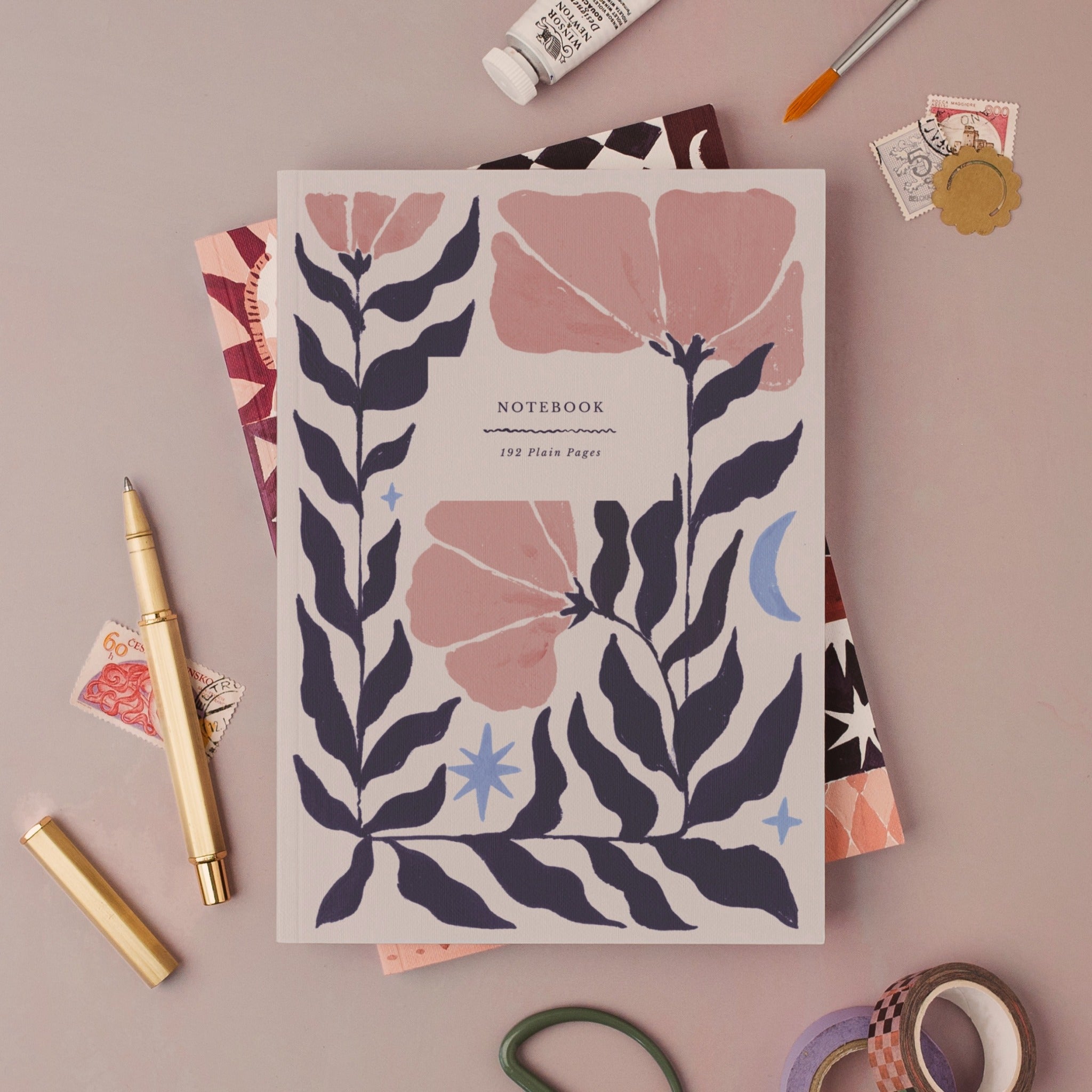 Botanical notebook, A5 plain page journal styled in a flat lay with a gold pen, paints and vintage stamps