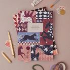 Wild & Free horse notebook, A5 plain page journal styled in a flat lay with a gold pen, paints and vintage stamps