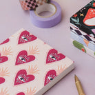 Sacred heart pocket notebook styled with props