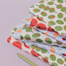 Sister Paper Co olives notebook and gift wrap styled together