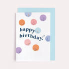 A cute birthday card with happy birthday lettering and smiley faces on a birthday card from the birthday card collection at Sister Paper Co.